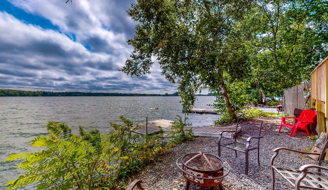 Dog-friendly lakefront home with dock, fireplace, firepit, lake views, & 1 kayak