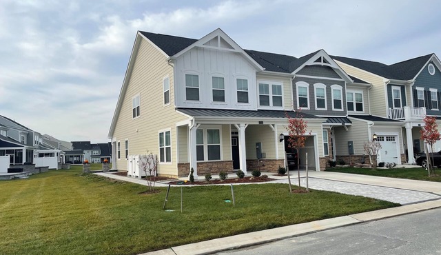 Newly built end unit townhouse with Pond views in The Peninsula!