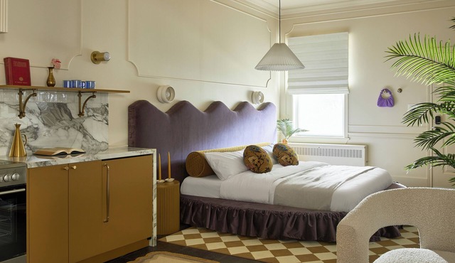 This neutral flat packs a punch with a unique and interesting feature—a round king size bed!